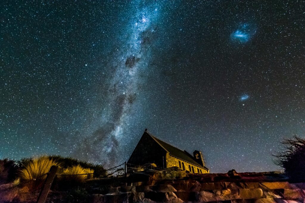 Captivating night sky with Milky Way over a historic church, ideal for astronomy enthusiasts.